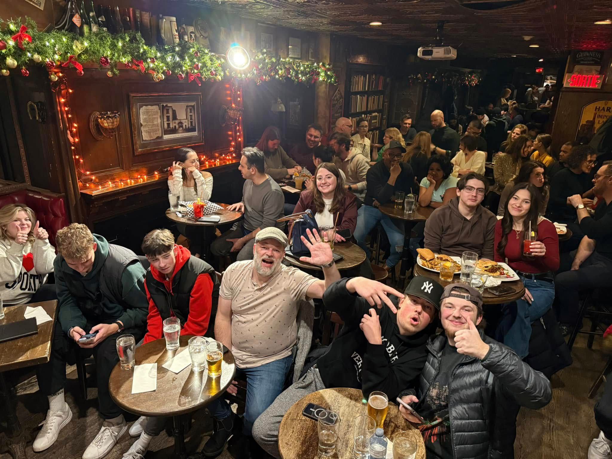 A group of people sitting at tables in a room.